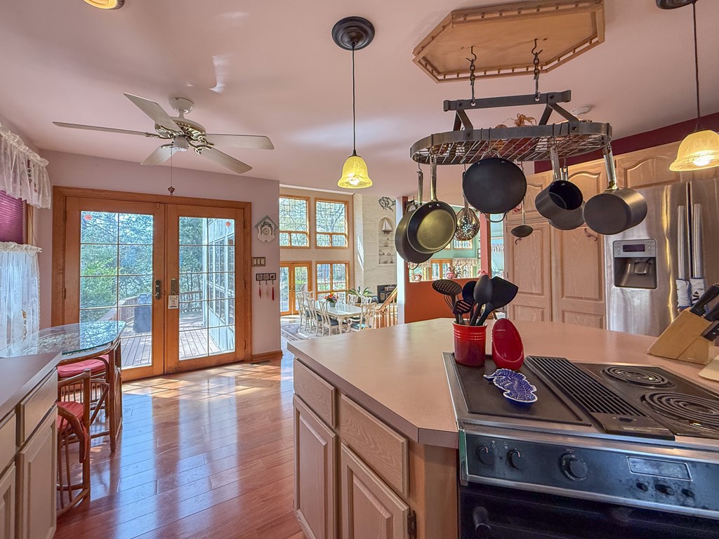 13581 Solitude Trail Machipongo, VA 23405 - Photo 10 of 51 a kitchen with a stove a sink and wooden floor