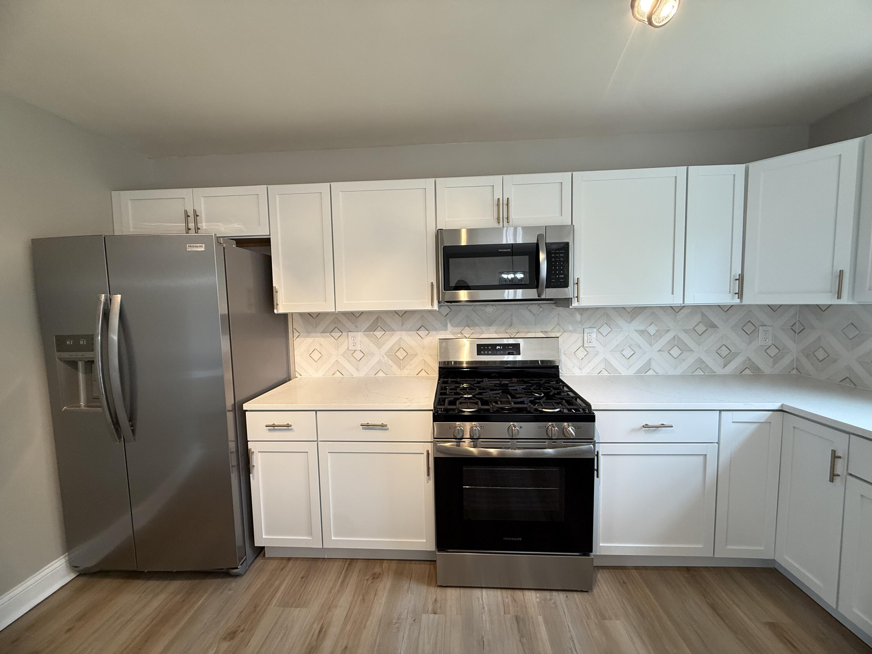 15895 Sherman Street Lowell, IN 46356 - Photo 14 of 36 a kitchen with a sink a stove and refrigerator