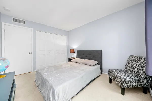 a bedroom with a bed and a couch