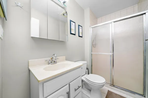 a bathroom with a sink toilet and mirror