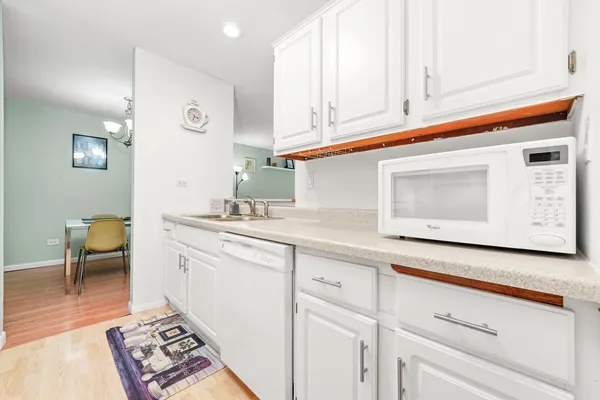 a kitchen with a sink cabinets and wooden floor
