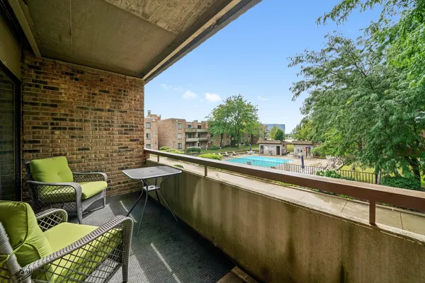 a balcony with table and chairs
