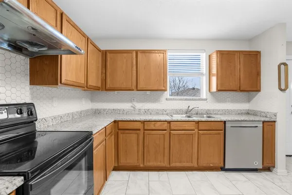 a kitchen with granite countertop a sink and cabinets