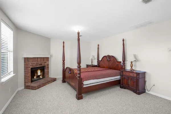 a bed room with furniture and a fireplace