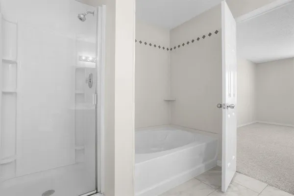 a bathroom with a bathtub and shower