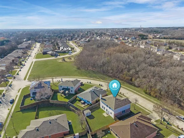 an aerial view of a house with a swimming pool