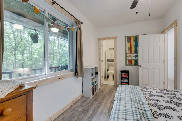 a view of a bedroom with furniture and windows