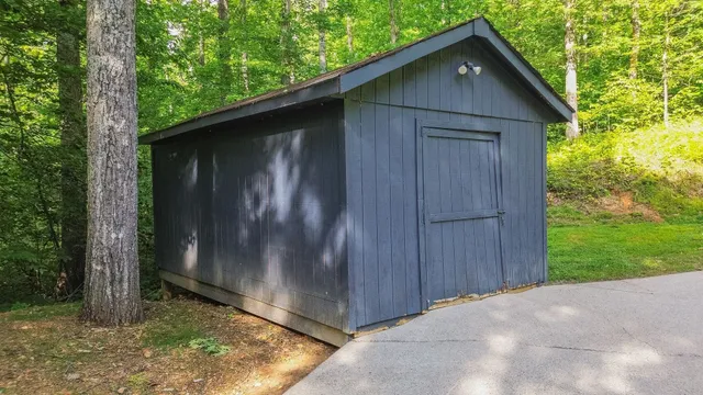 a wooden door in front of a house with a yard