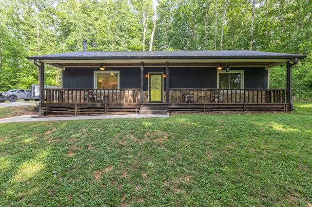 a view of a house with a yard and deck