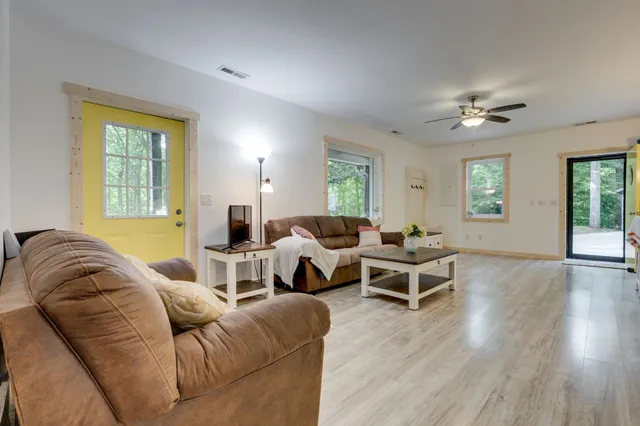 a bedroom with sink a bed and a large window