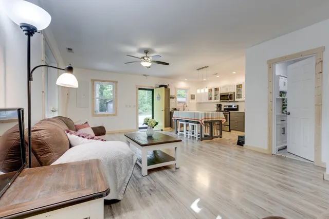 a living room with furniture and a wooden floor
