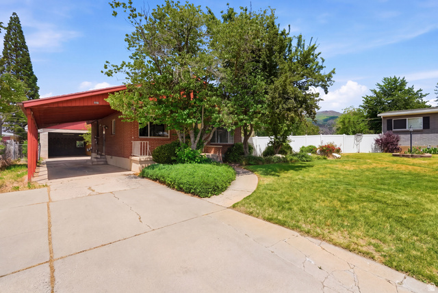 378 West 200 South Bountiful, UT 84010 - Photo 3 of 32 Brick exterior with a red-toned carport, established front yard landscaping, and a concrete driveway