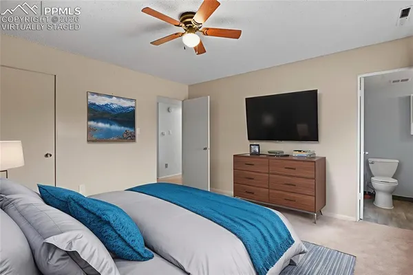 a bathroom with a granite countertop sink and a toilet