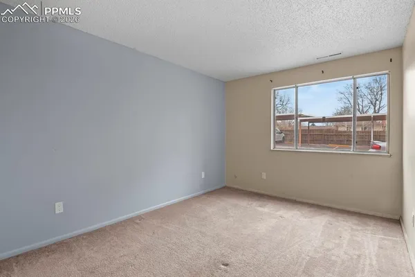 a bedroom with bed and a window