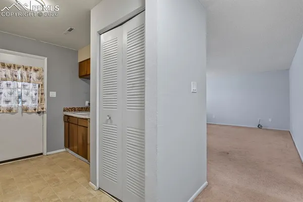 a view of a kitchen with a sink a refrigerator and window