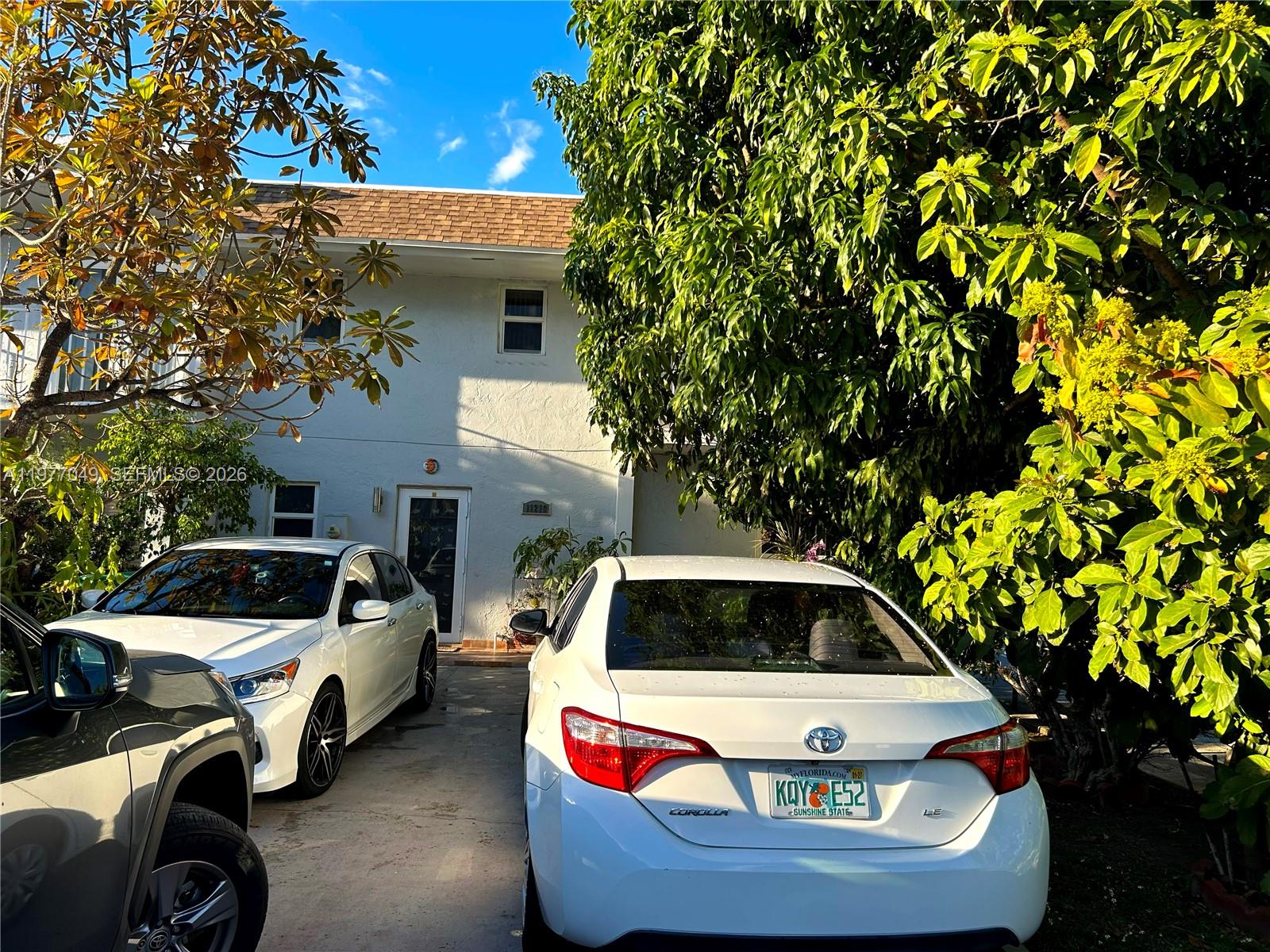 11219 Southwest 33 Rd Circle Place Brooklyn, FL 11219 - Photo 16 of 17 a front view of a house with a garden