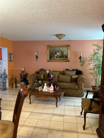 a living room with furniture and a painting on the wall