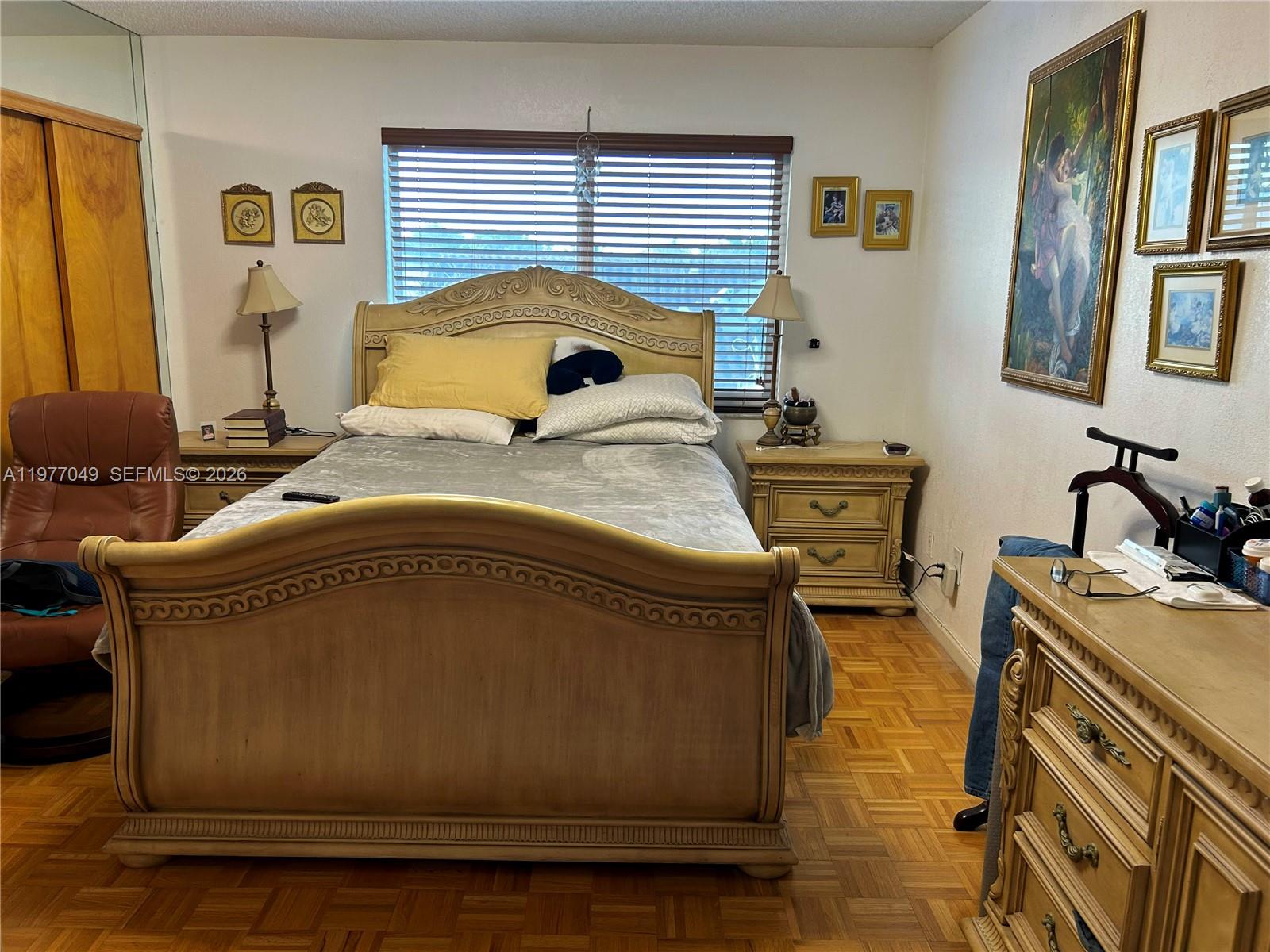 11219 Southwest 33 Rd Circle Place Brooklyn, FL 11219 - Photo 6 of 17 a bedroom with a bed and wooden floor