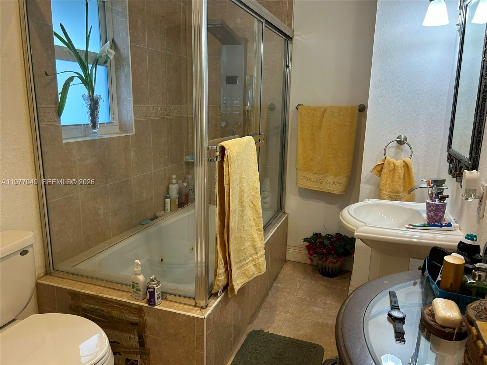 11219 Southwest 33 Rd Circle Place Brooklyn, FL 11219 - Photo 9 of 17 a bathroom with a sink toilet and shower