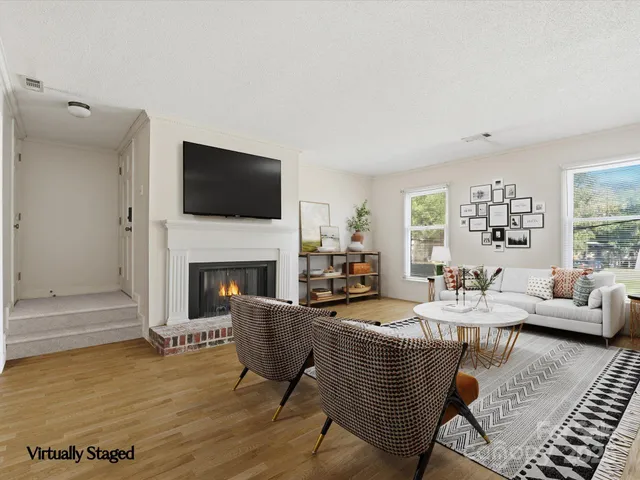 a living room with fireplace furniture and a flat screen tv