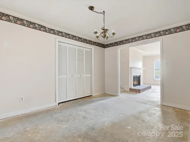 a view of a livingroom with a chandelier a dinning table and chairs