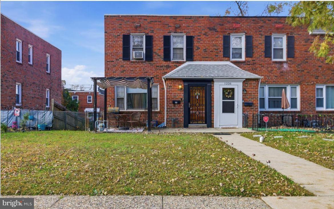 Charming brick duplex with inviting entrance.