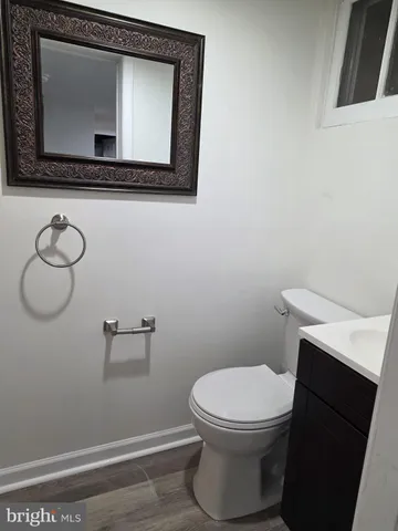 a bathroom with a toilet a sink and mirror