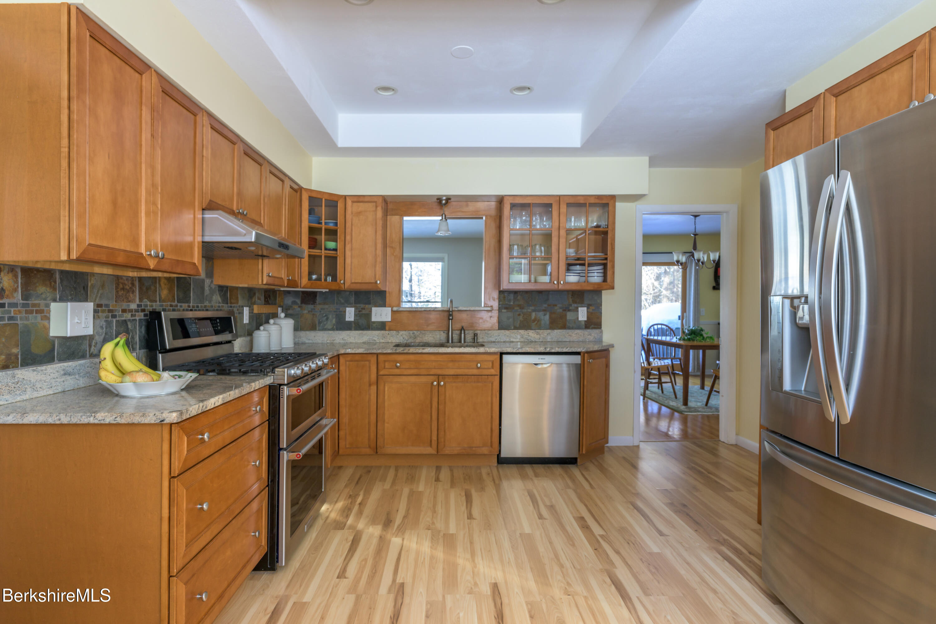 40 Leroi Drive Pittsfield, MA 01201 - Photo 13 of 38 a kitchen with stainless steel appliances granite countertop a refrigerator a sink dishwasher a stove with wooden cabinets and floor