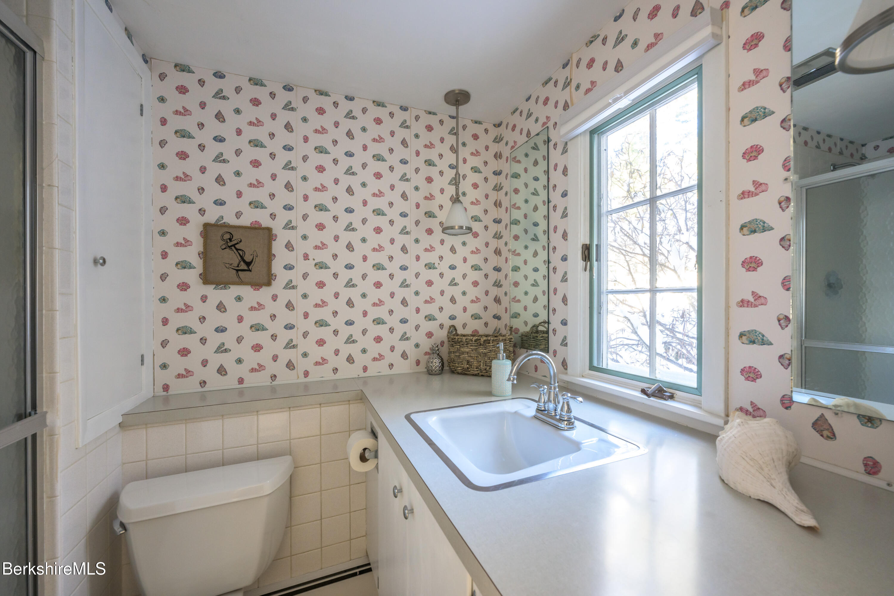 40 Leroi Drive Pittsfield, MA 01201 - Photo 34 of 38 a bathroom with a sink a toilet and window