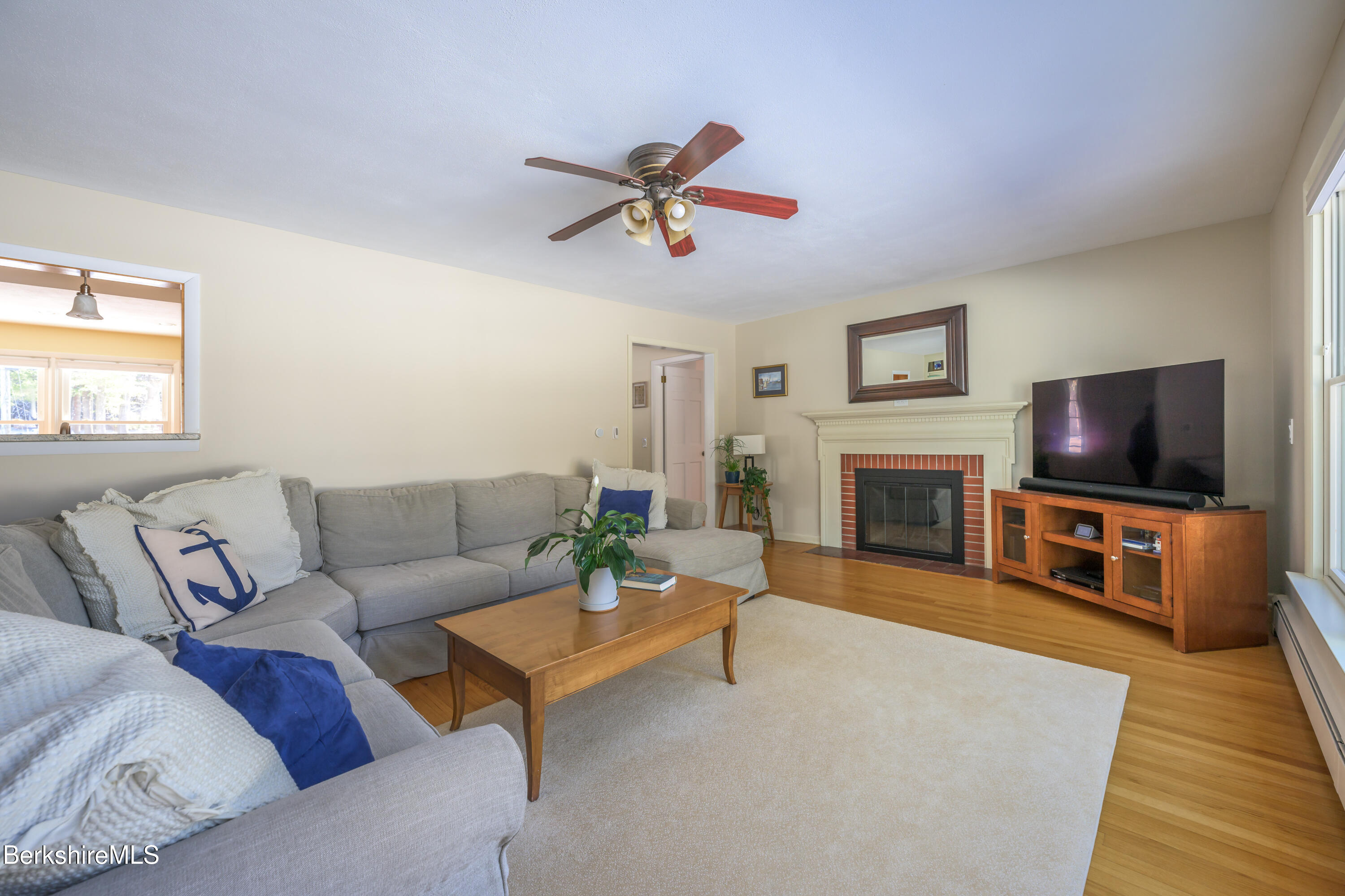 40 Leroi Drive Pittsfield, MA 01201 - Photo 10 of 38 a living room with furniture a fireplace and a flat screen tv
