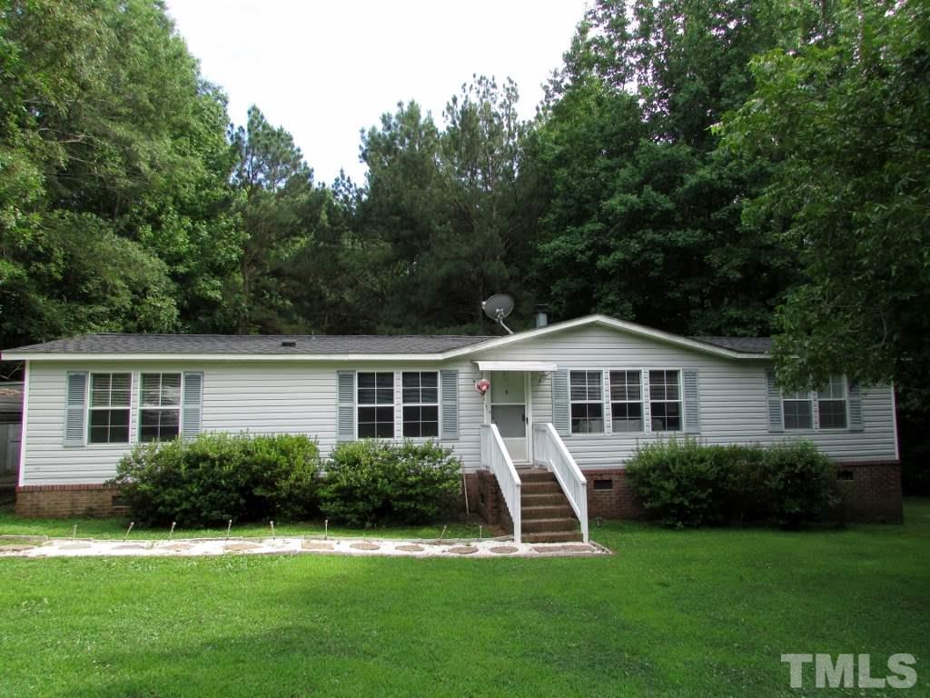 4128 Allensville Road Roxboro, NC 27574 - Photo 1 of 24 a front view of a house with a yard and green space