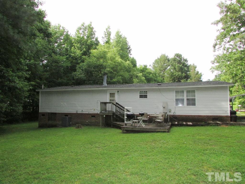 4128 Allensville Road Roxboro, NC 27574 - Photo 15 of 24 a front view of a house with a garden and chairs