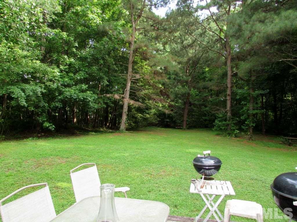 4128 Allensville Road Roxboro, NC 27574 - Photo 16 of 24 a swimming pool with some trees in the background