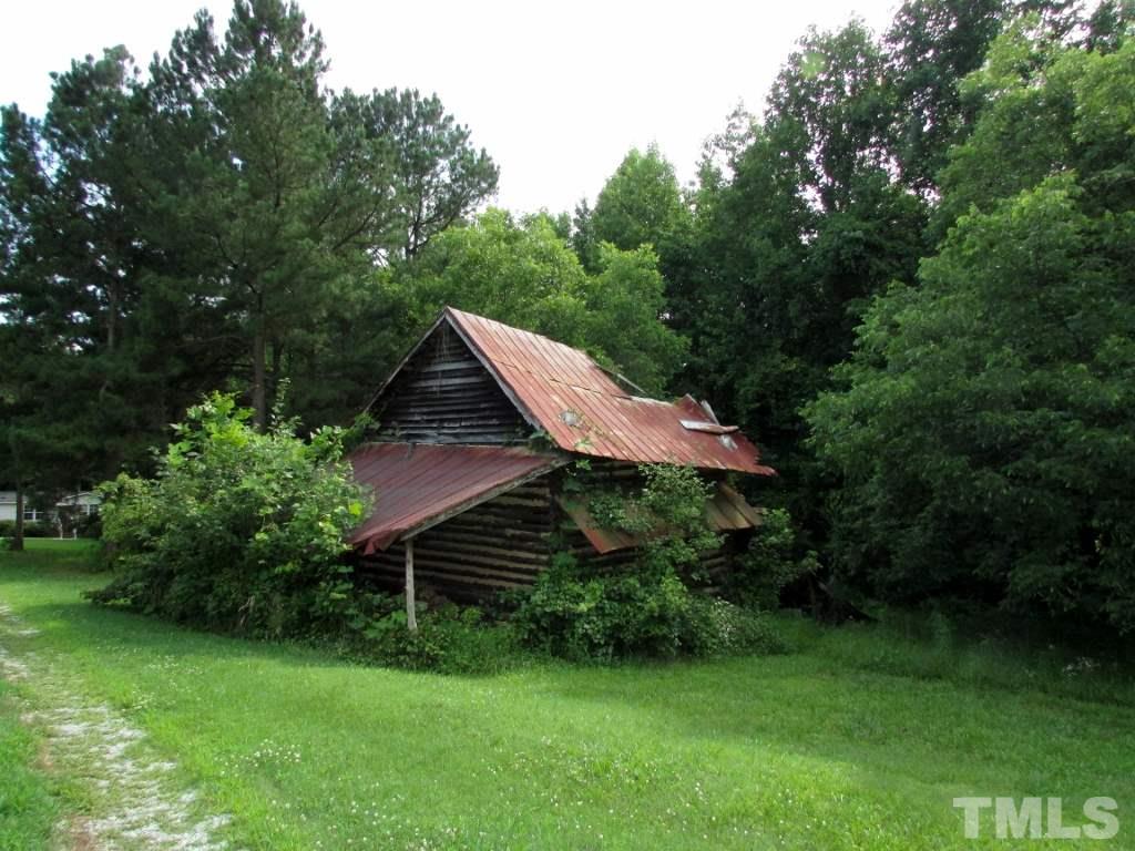 4128 Allensville Road Roxboro, NC 27574 - Photo 17 of 24 a view of a backyard with plants and a garden