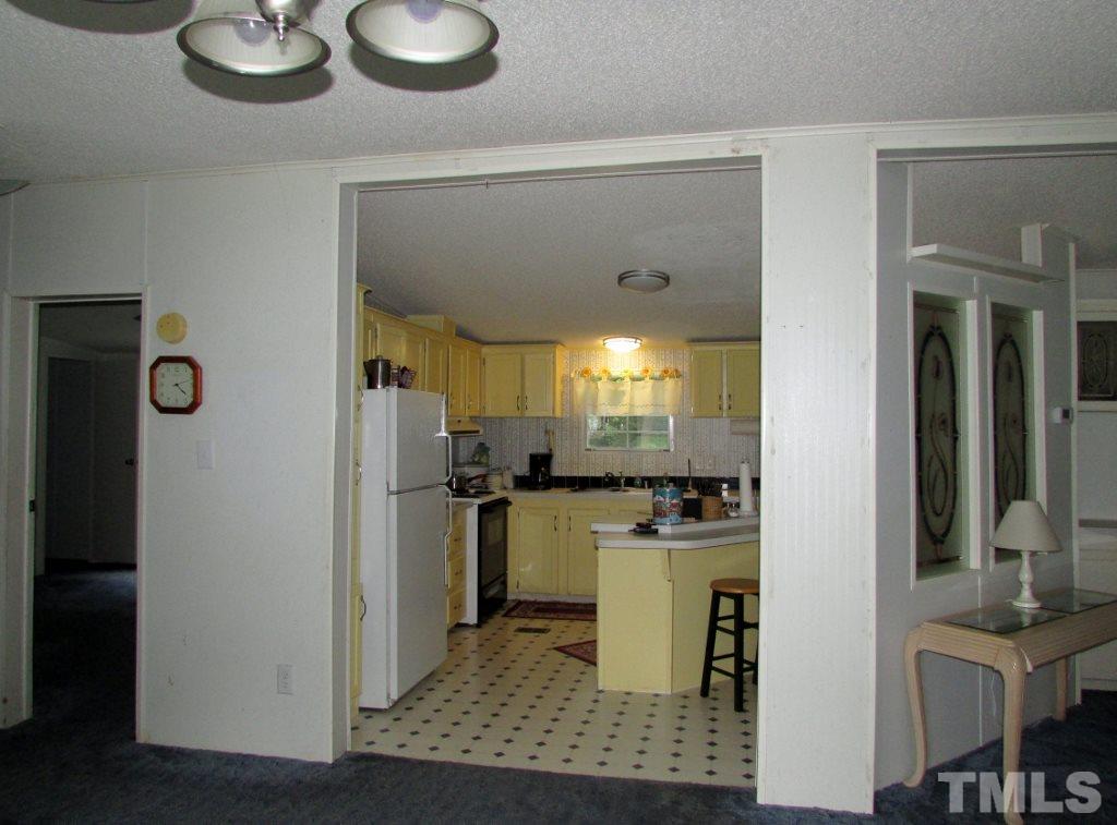4128 Allensville Road Roxboro, NC 27574 - Photo 5 of 24 a kitchen with a refrigerator and a stove