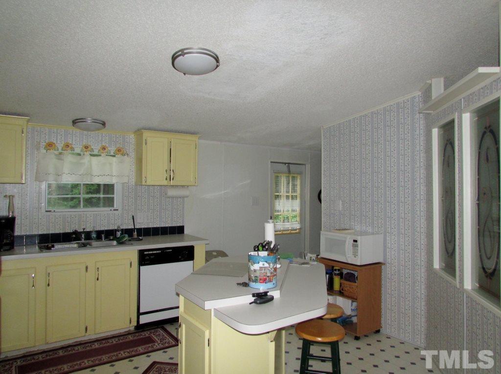 4128 Allensville Road Roxboro, NC 27574 - Photo 7 of 24 a kitchen with a sink and cabinets
