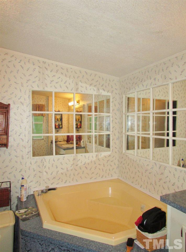 4128 Allensville Road Roxboro, NC 27574 - Photo 10 of 24 a bath tub sitting in front of a house