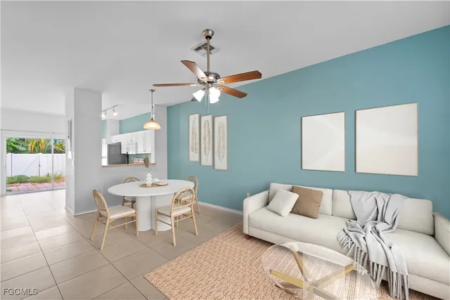 a living room with furniture a chandelier and a window