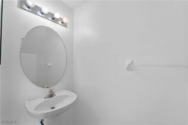 a bathroom with a sink and mirror