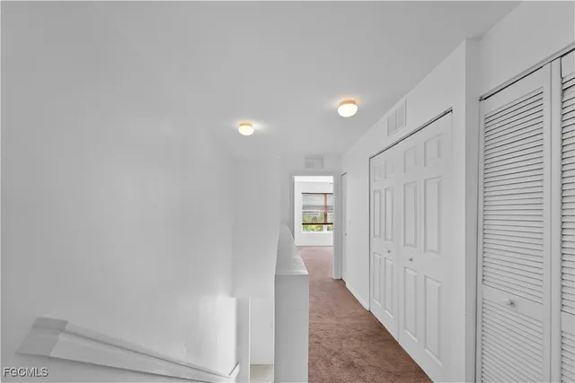 a view of a hallway with closet and entryway