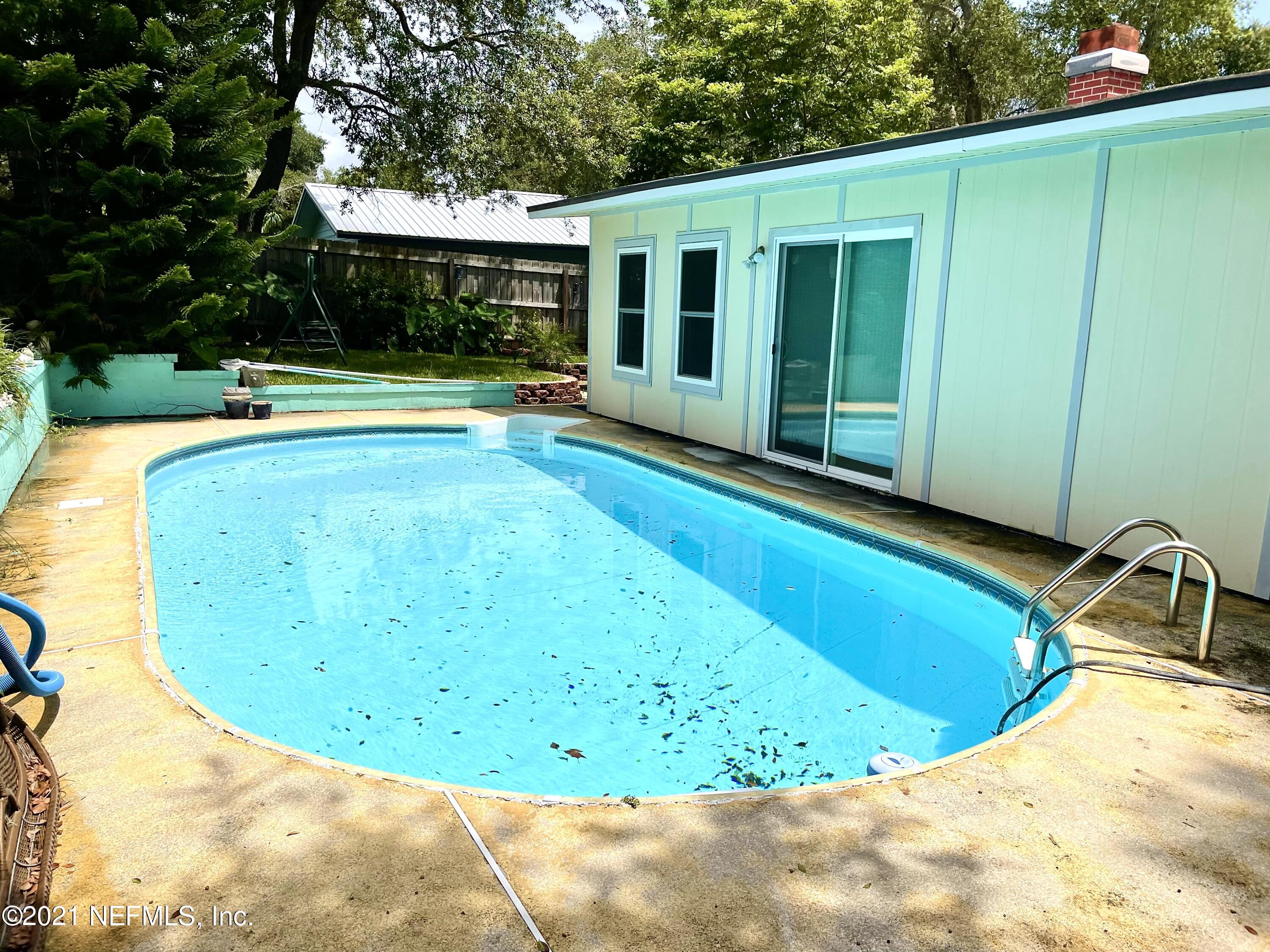 a view of a swimming pool with a patio