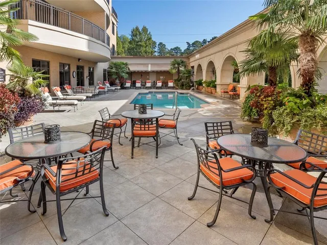 a backyard of a house with yard table and chairs