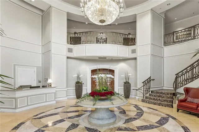 a living room with fireplace furniture and a chandelier