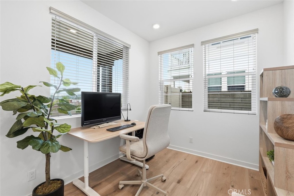 361 Gelding Way Rancho Mission Viejo, CA 92694 - Photo 12 of 59 a view of a workspace with furniture and a potted plant