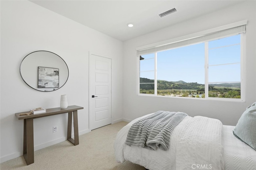 361 Gelding Way Rancho Mission Viejo, CA 92694 - Photo 32 of 59 a room with a bed a mirror and a window