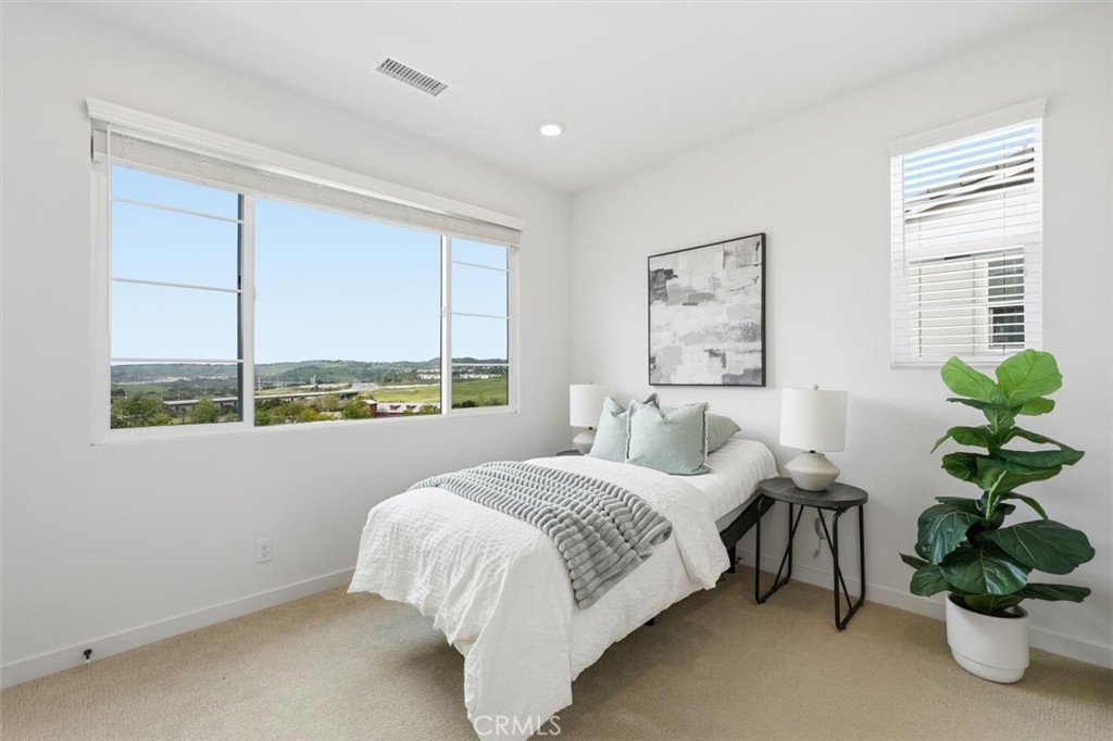 361 Gelding Way Rancho Mission Viejo, CA 92694 - Photo 33 of 59 a bedroom with a bed potted plant and a large window