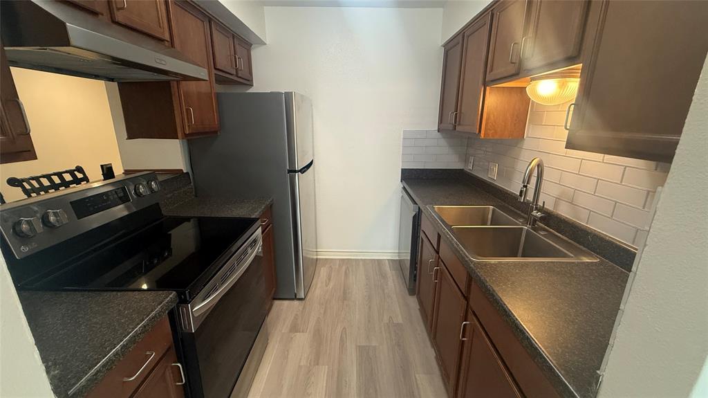 500 East Riverside Drive, Unit 132 Austin, TX 78704 - Photo 5 of 31 a kitchen with granite countertop a refrigerator stove and sink