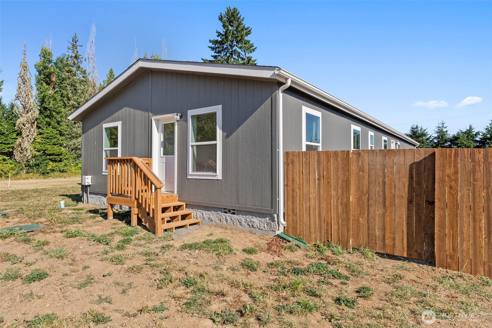 1088 Koontz Road Napavine, WA 98532 - Photo 29 of 36 a view of a house with wooden fence and a bench