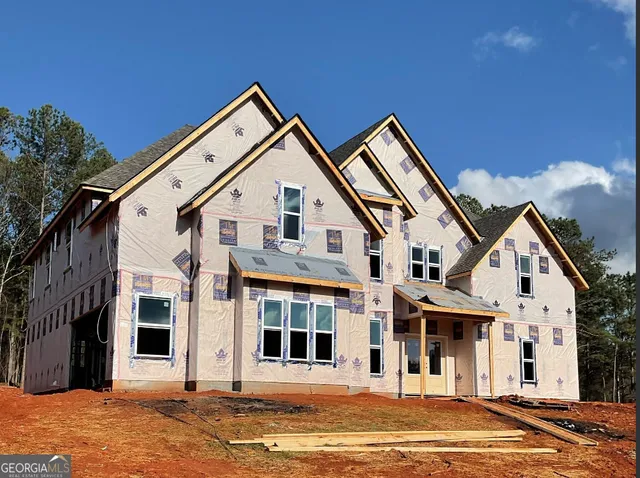 a view of a white house with a yard and plants