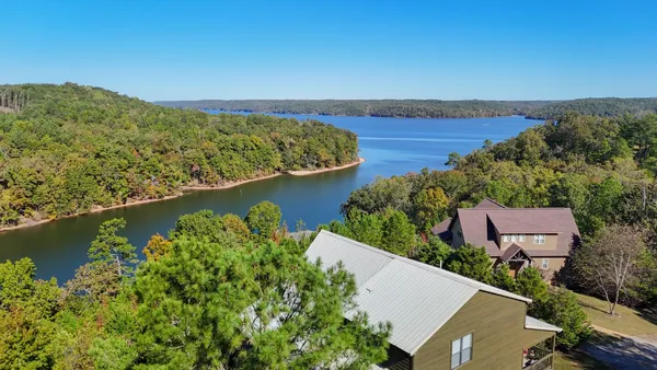 an aerial view of a house with a lake view